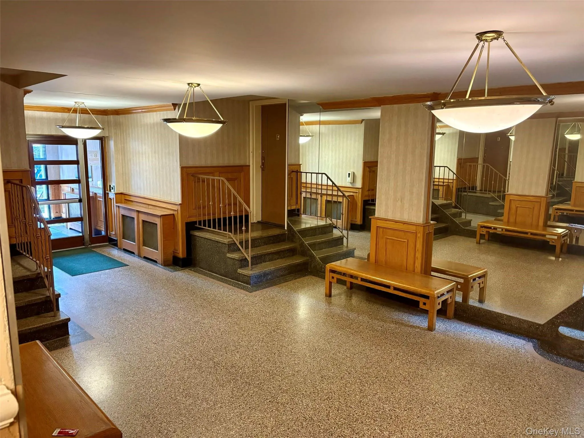 Lobby with wainscoting and wallpapered walls Lobby with wainscoting and wallpapered walls