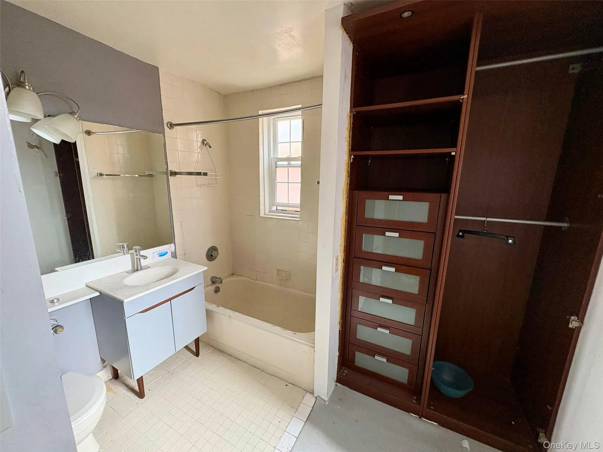 Bathroom featuring vanity and washtub / shower combination Bathroom featuring vanity and washtub / shower combination