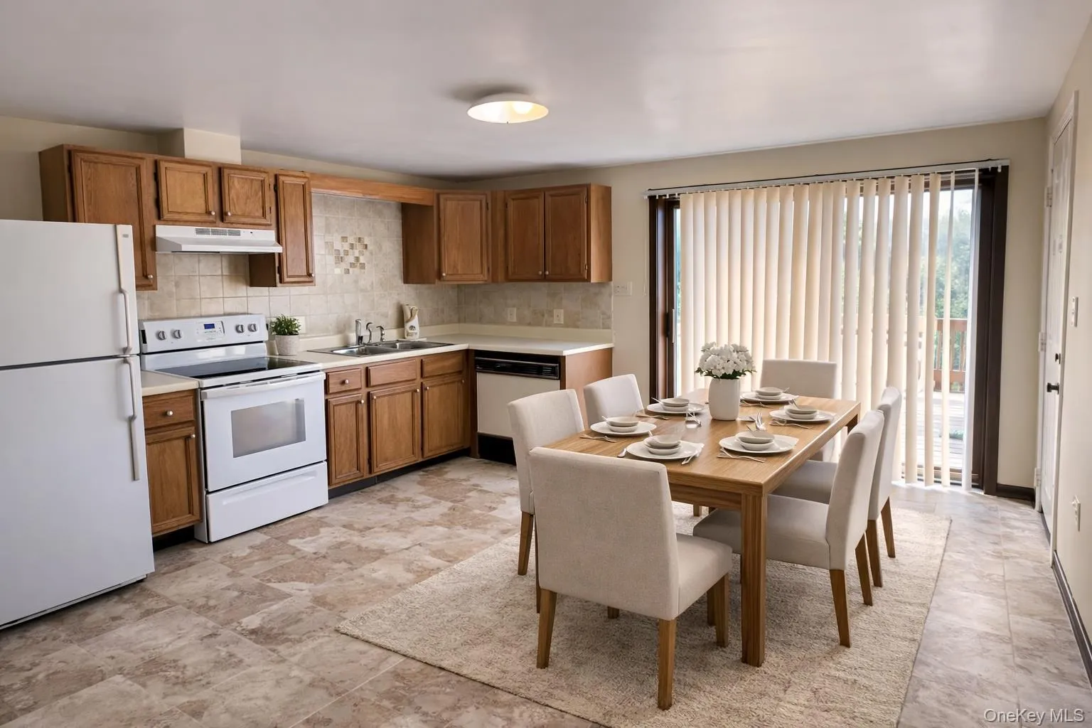 Kitchen with white appliances, light countertops, and wood finish cabinets Kitchen with white appliances, light countertops, and wood finish cabinets