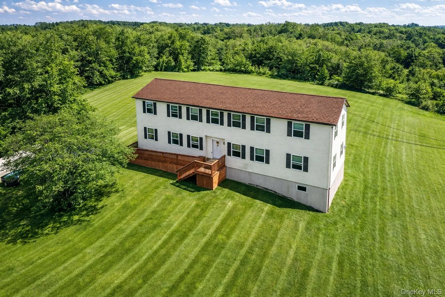 Aerial view of property and surrounding area with a forest Aerial view of property and surrounding area with a forest
