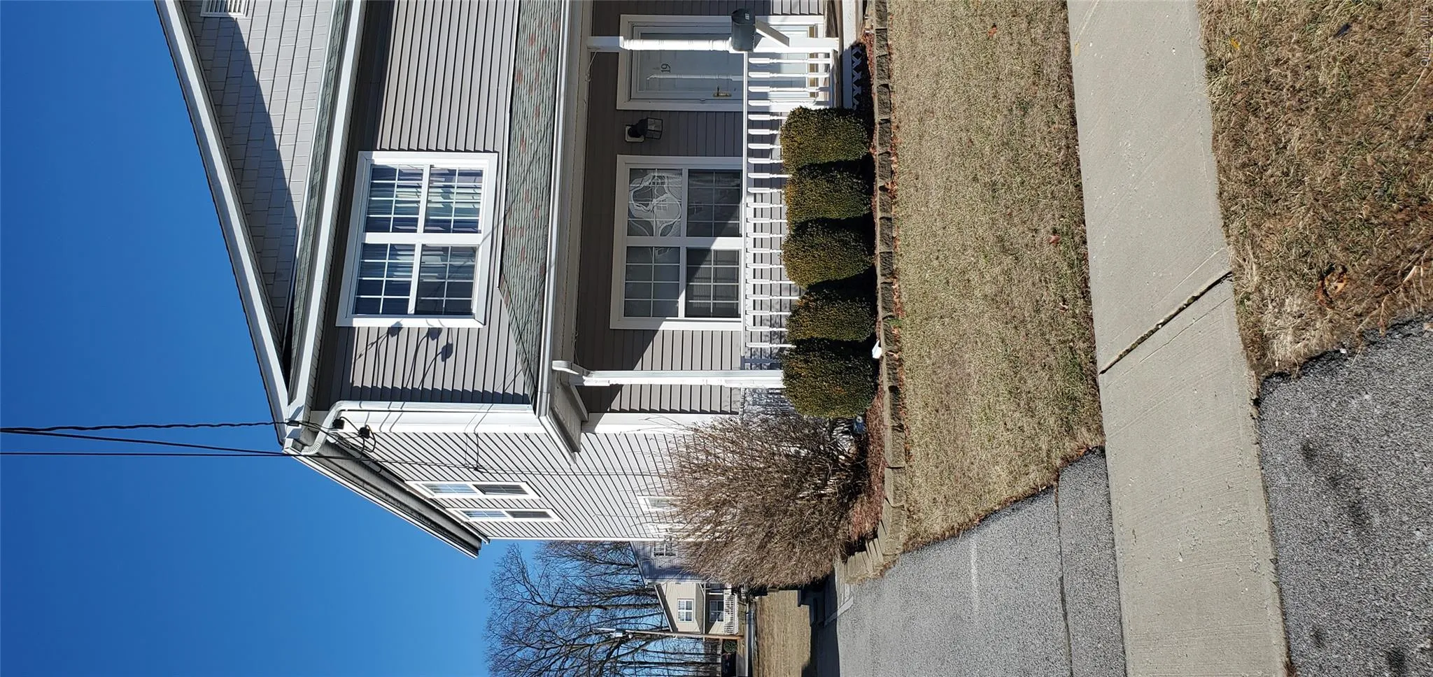 View of side of home featuring a yard View of side of home featuring a yard
