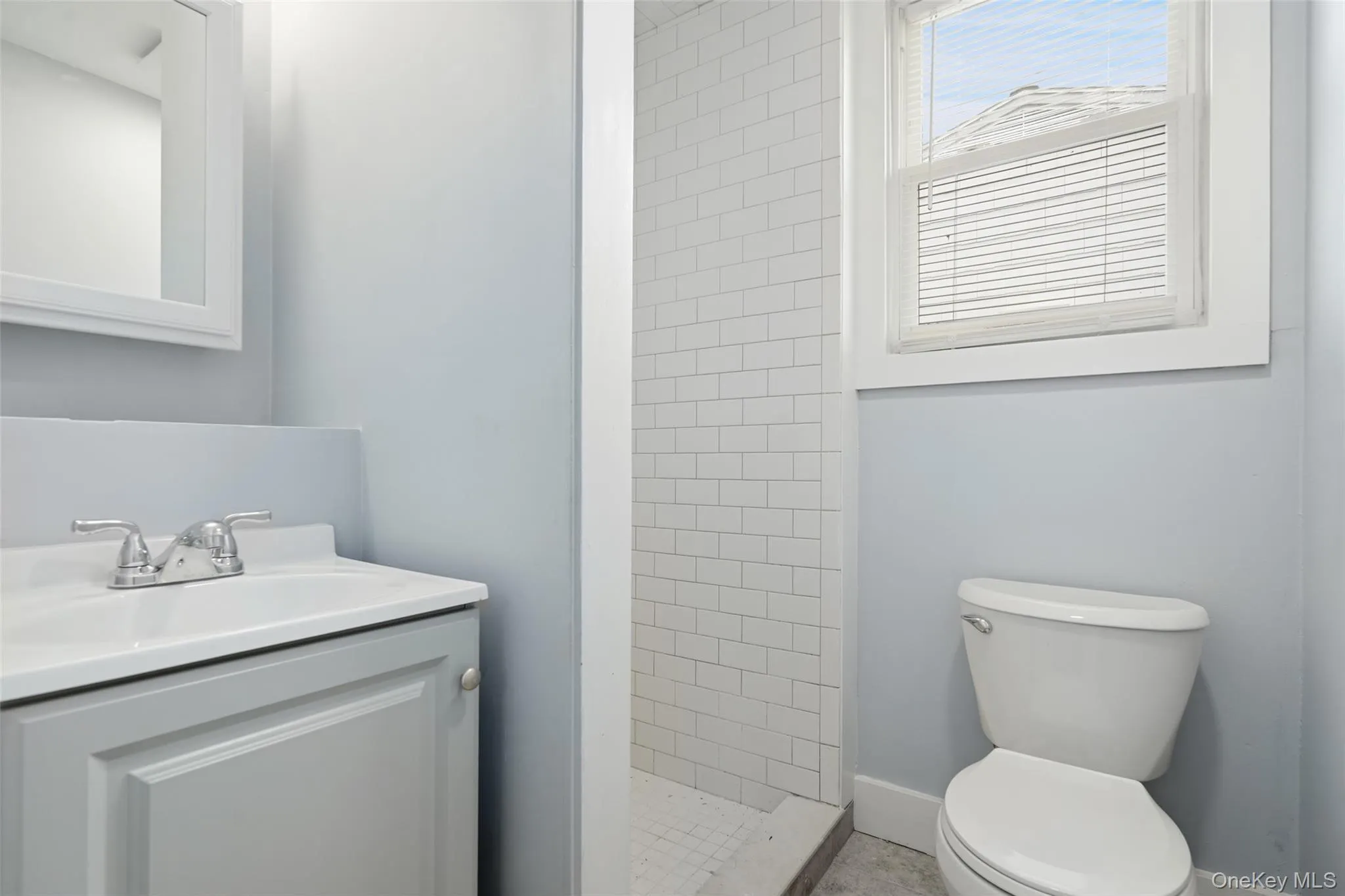 Bathroom featuring vanity and a shower stall Bathroom featuring vanity and a shower stall