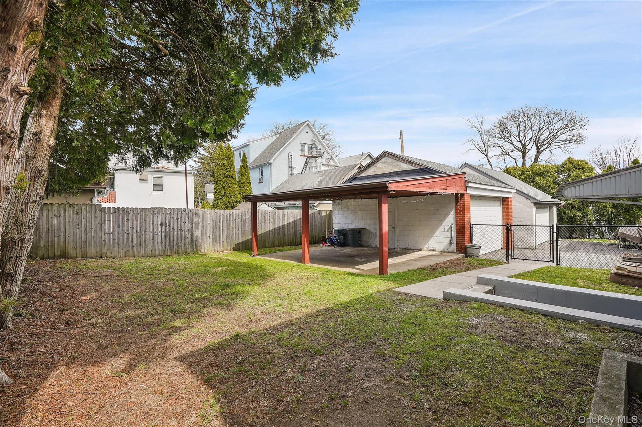 Fenced backyard with a patio area Fenced backyard with a patio area