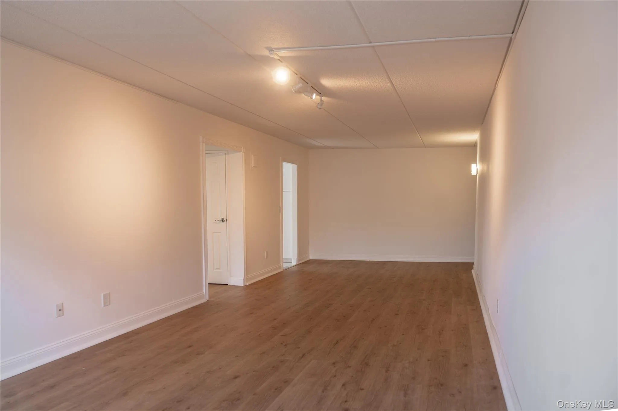 Another view of the living room showing the eating area and entrances from the kitchen and bedrom Another view of the living room showing the eating area and entrances from the kitchen and bedrom