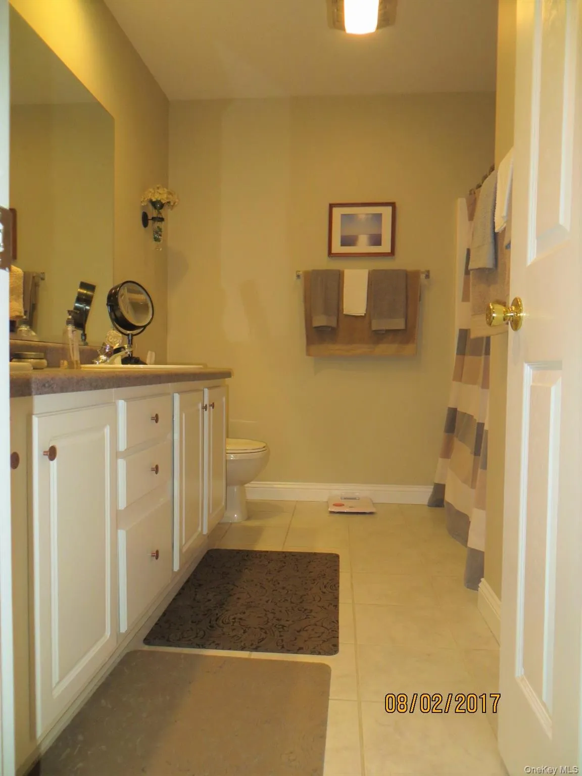 Full bathroom with vanity, tile patterned flooring, and curtained shower Full bathroom with vanity, tile patterned flooring, and curtained shower