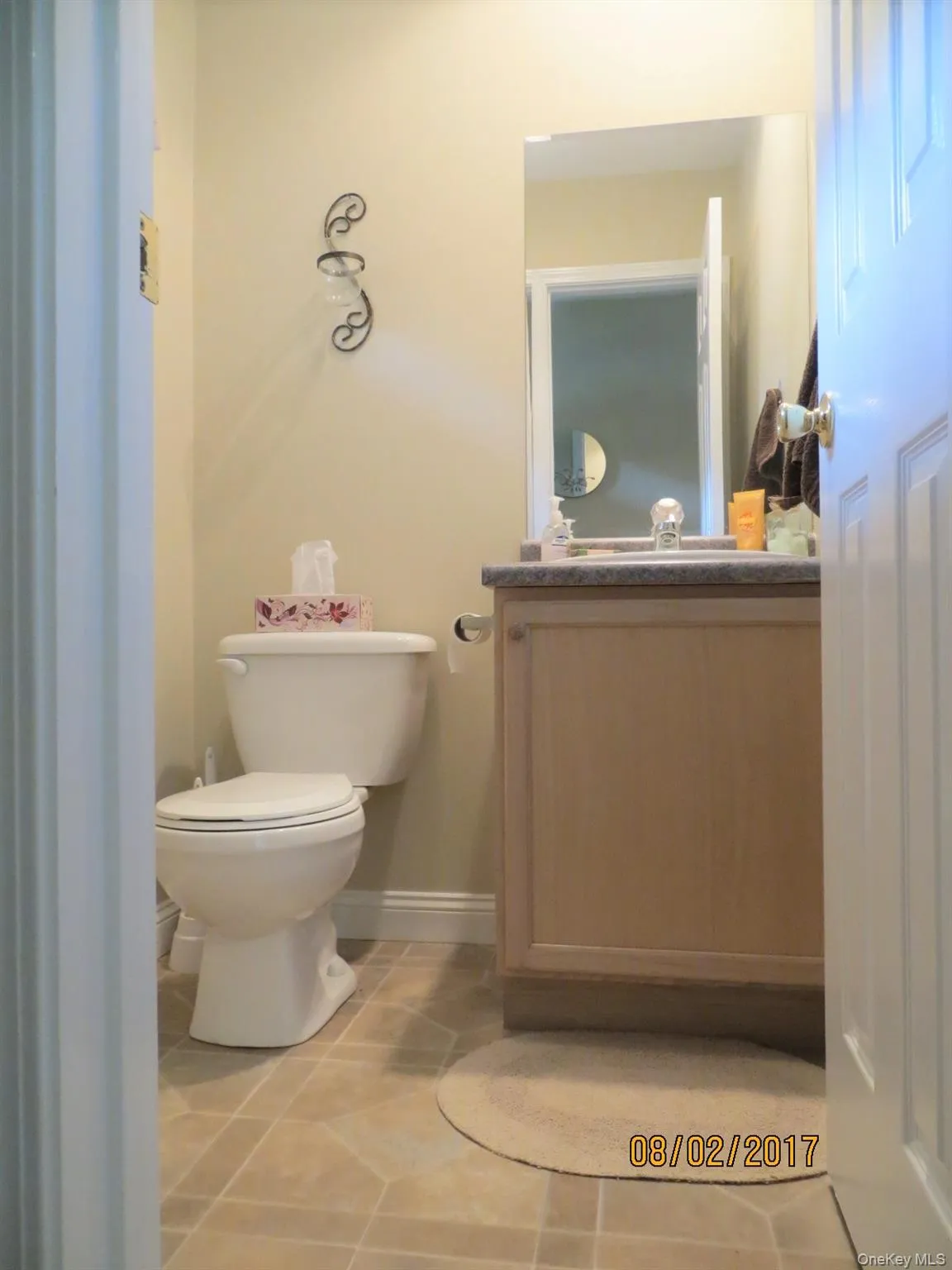 Half bathroom with vanity and tile patterned floors Half bathroom with vanity and tile patterned floors