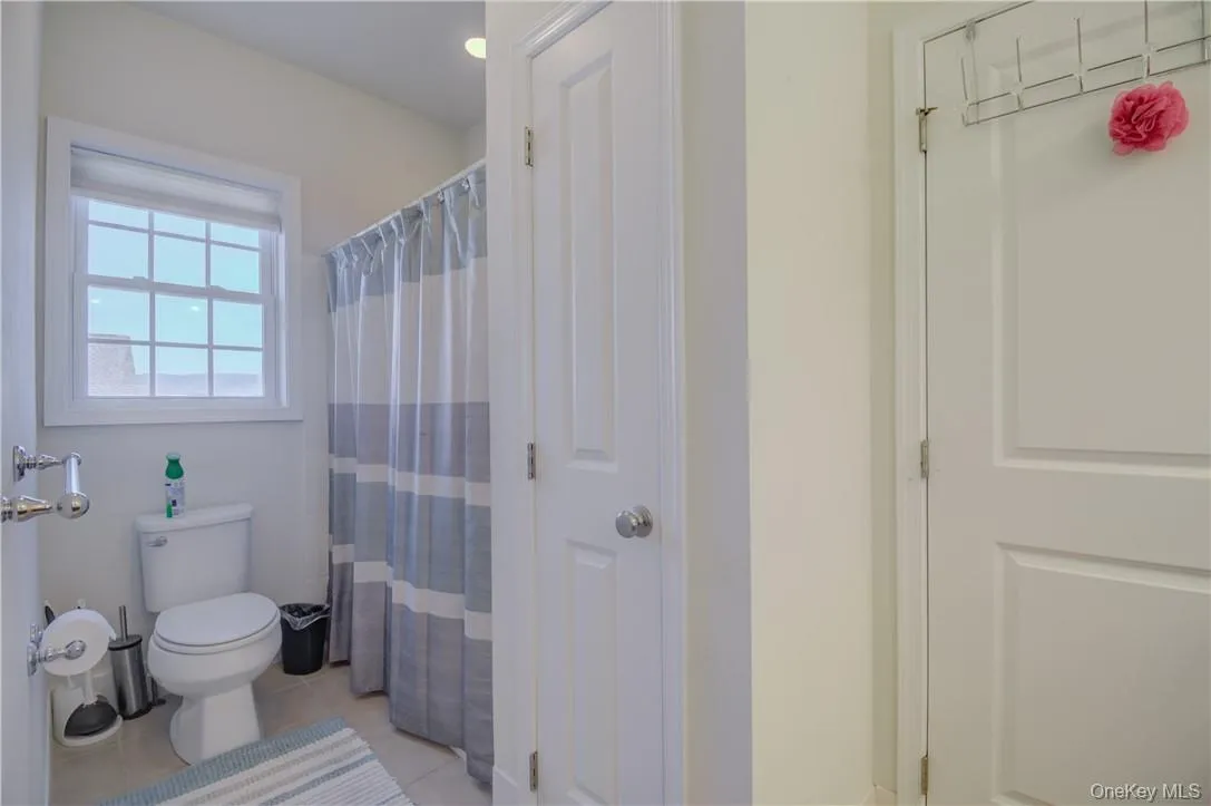 Jack and Jill Bathroom featuring tile flooring Jack and Jill Bathroom featuring tile flooring