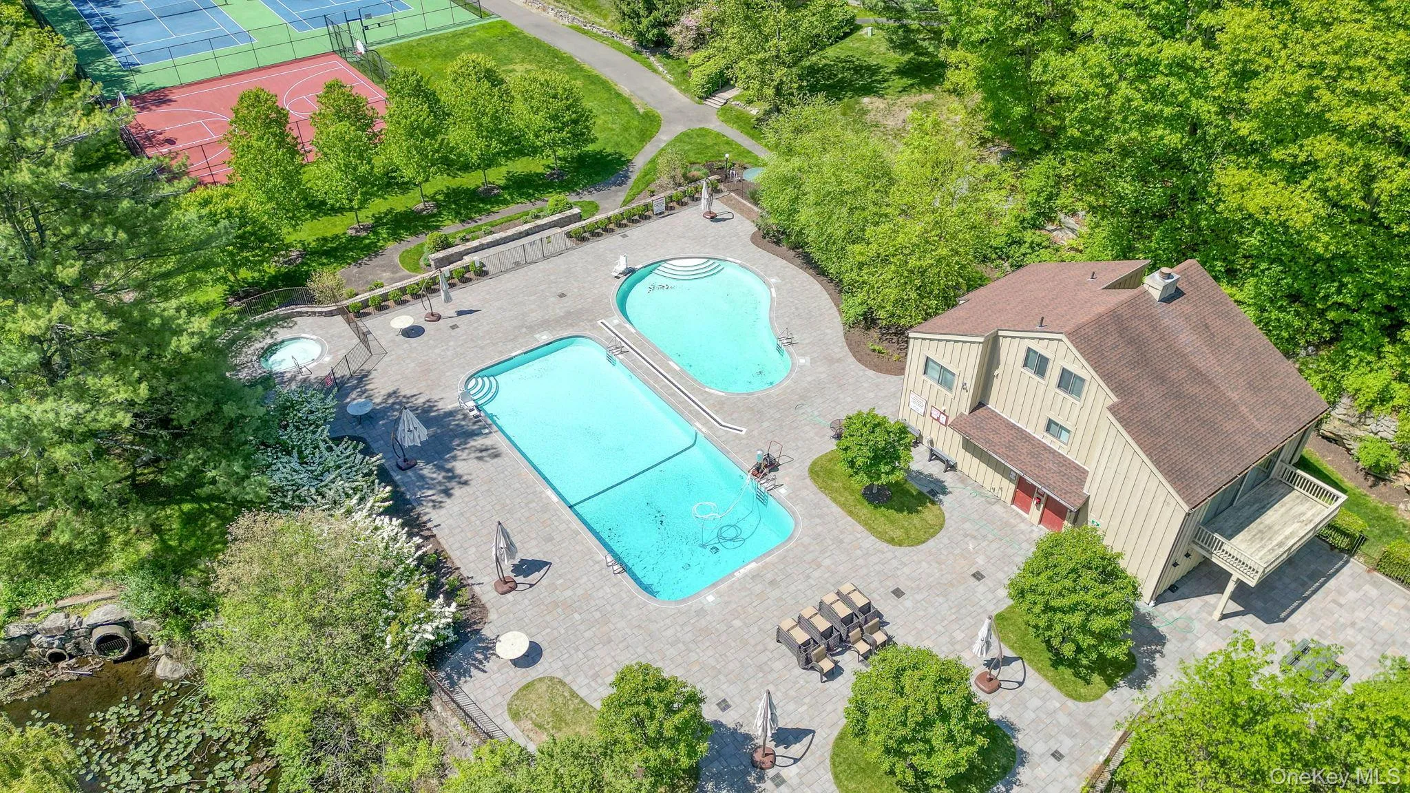 drone view of the club house and community pool drone view of the club house and community pool