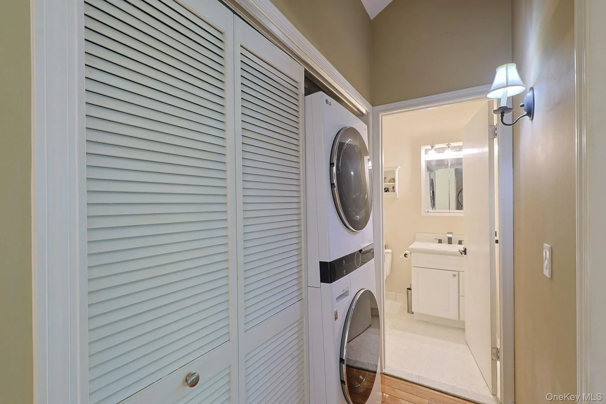 Laundry room located across from the primary bedroom and bathroom Laundry room located across from the primary bedroom and bathroom
