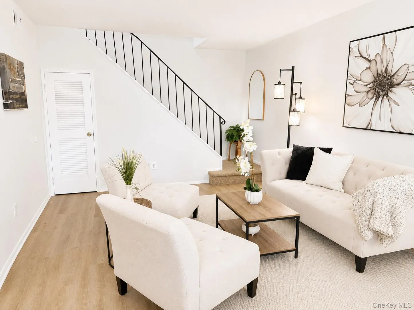 Welcome home to a warm and inviting living room that makes a wonderful first impression upon entry. This bright, open-concept space features updated flooring, neutral tones, and a comfortable layout designed for both everyday living and entertaining. The elegant staircase creates a striking focal point, while the spacious seating area offers plenty of room to relax and gather. With its seamless flow and abundant natural light, this living room serves as the perfect centerpiece of the home. Welcome home to a warm and inviting living room that makes a wonderful first impression upon entry. This bright, open-concept space features updated flooring, neutral tones, and a comfortable layout designed for both everyday living and entertaining. The elegant staircase creates a striking focal point, while the spacious seating area offers plenty of room to relax and gather. With its seamless flow and abundant natural light, this living room serves as the perfect centerpiece of the home.