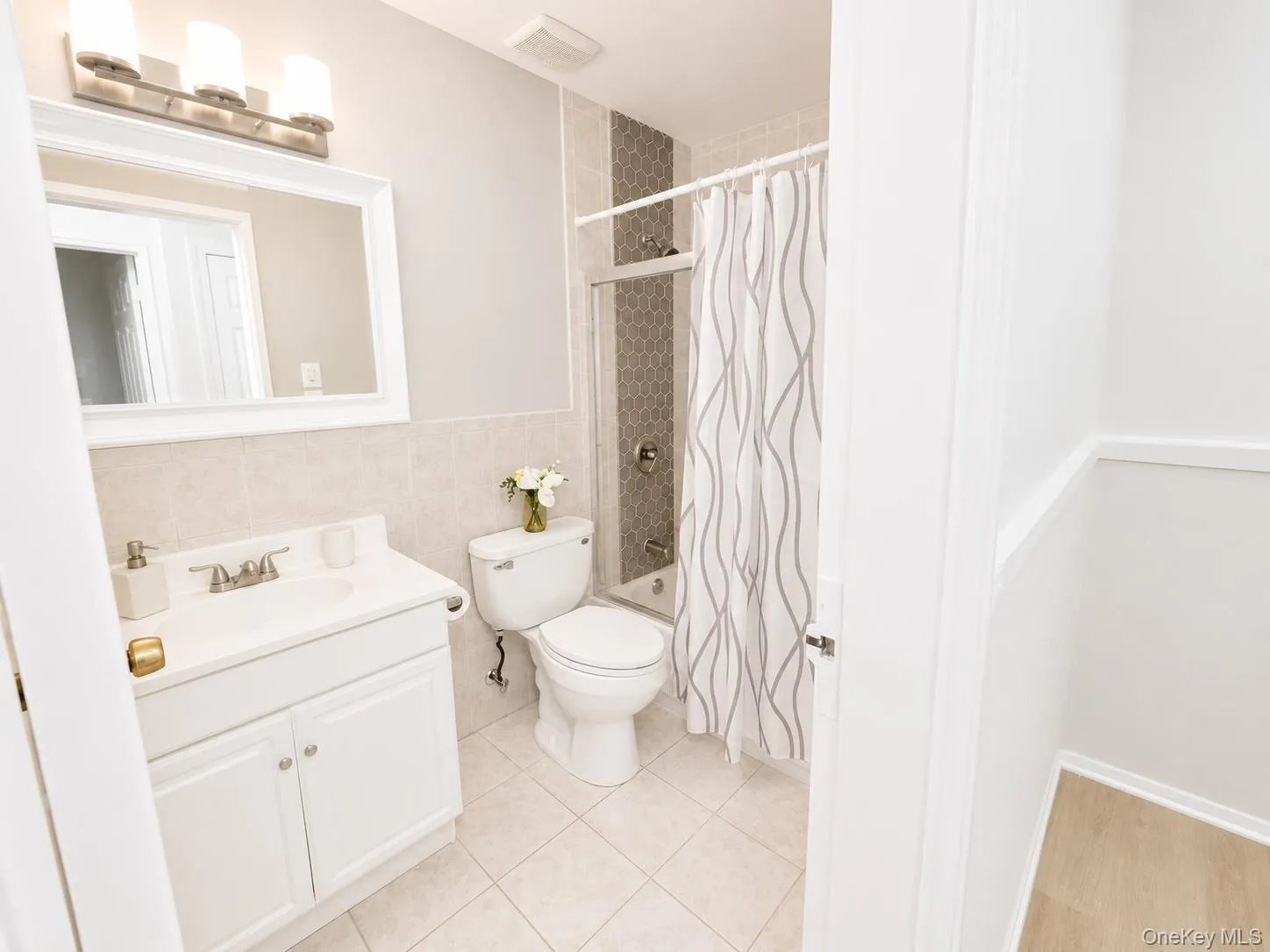The updated full bathroom offers a clean, modern design with neutral finishes that complement any décor. Featuring an updated vanity, stylish lighting, and a beautifully tiled tub/shower combination with decorative accent tile, this space is both functional and inviting. The bright, neutral palette creates a fresh and timeless look, making it the perfect place to start and end your day. The updated full bathroom offers a clean, modern design with neutral finishes that complement any décor. Featuring an updated vanity, stylish lighting, and a beautifully tiled tub/shower combination with decorative accent tile, this space is both functional and inviting. The bright, neutral palette creates a fresh and timeless look, making it the perfect place to start and end your day.