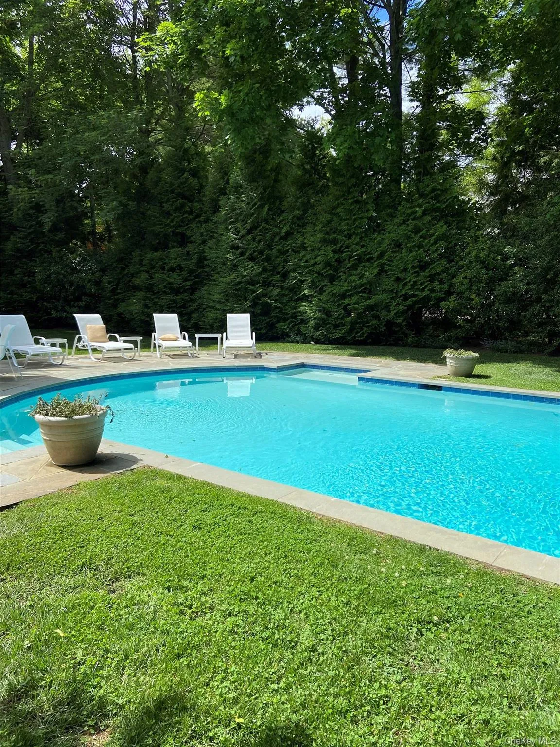 View of pool with a lawn View of pool with a lawn