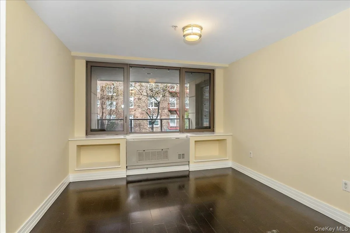 Unfurnished dining area with dark wood-type flooring and baseboards Unfurnished dining area with dark wood-type flooring and baseboards