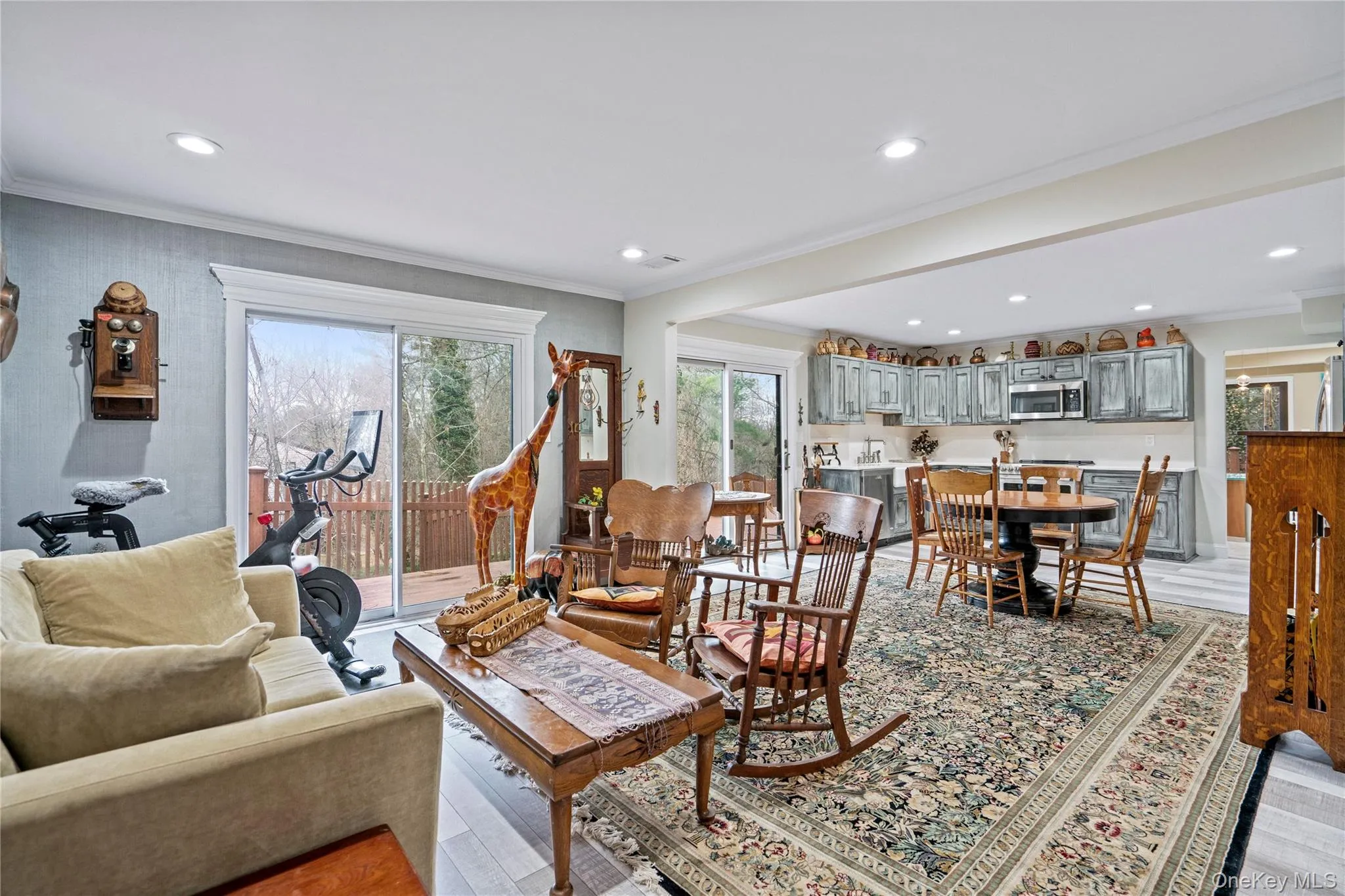 Living area with crown molding, healthy amount of natural light, and recessed lighting Living area with crown molding, healthy amount of natural light, and recessed lighting