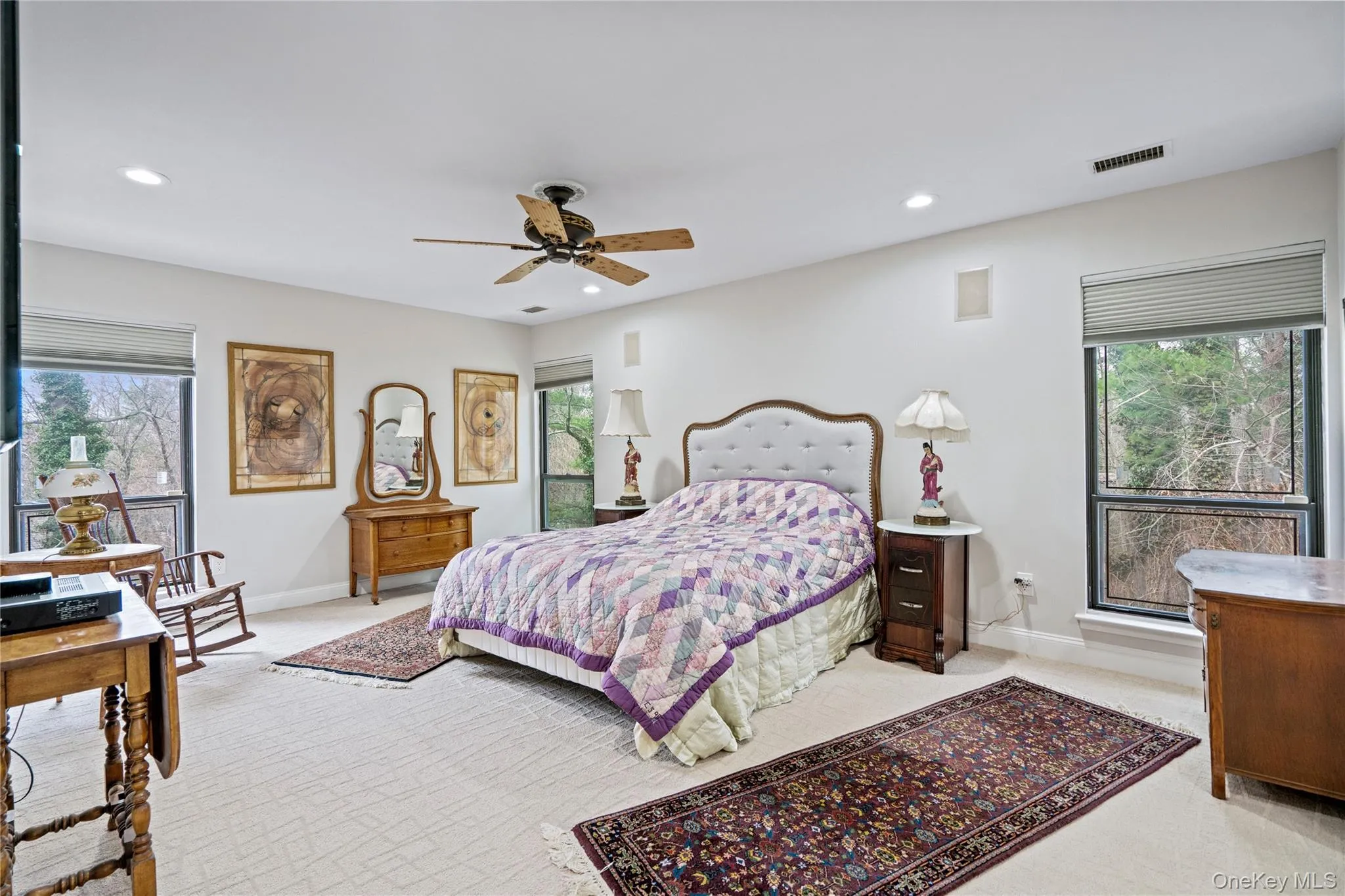 Bedroom with light carpet, a ceiling fan, and recessed lighting Bedroom with light carpet, a ceiling fan, and recessed lighting