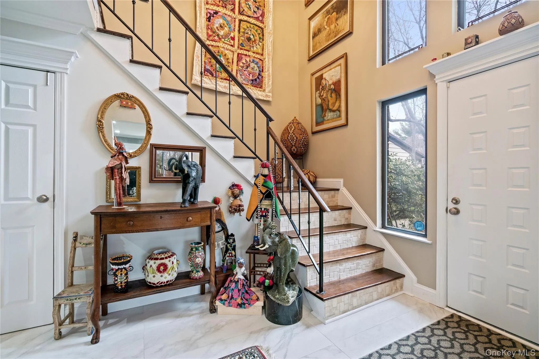 Foyer entrance with stairs and a high ceiling leading to second floor Foyer entrance with stairs and a high ceiling leading to second floor