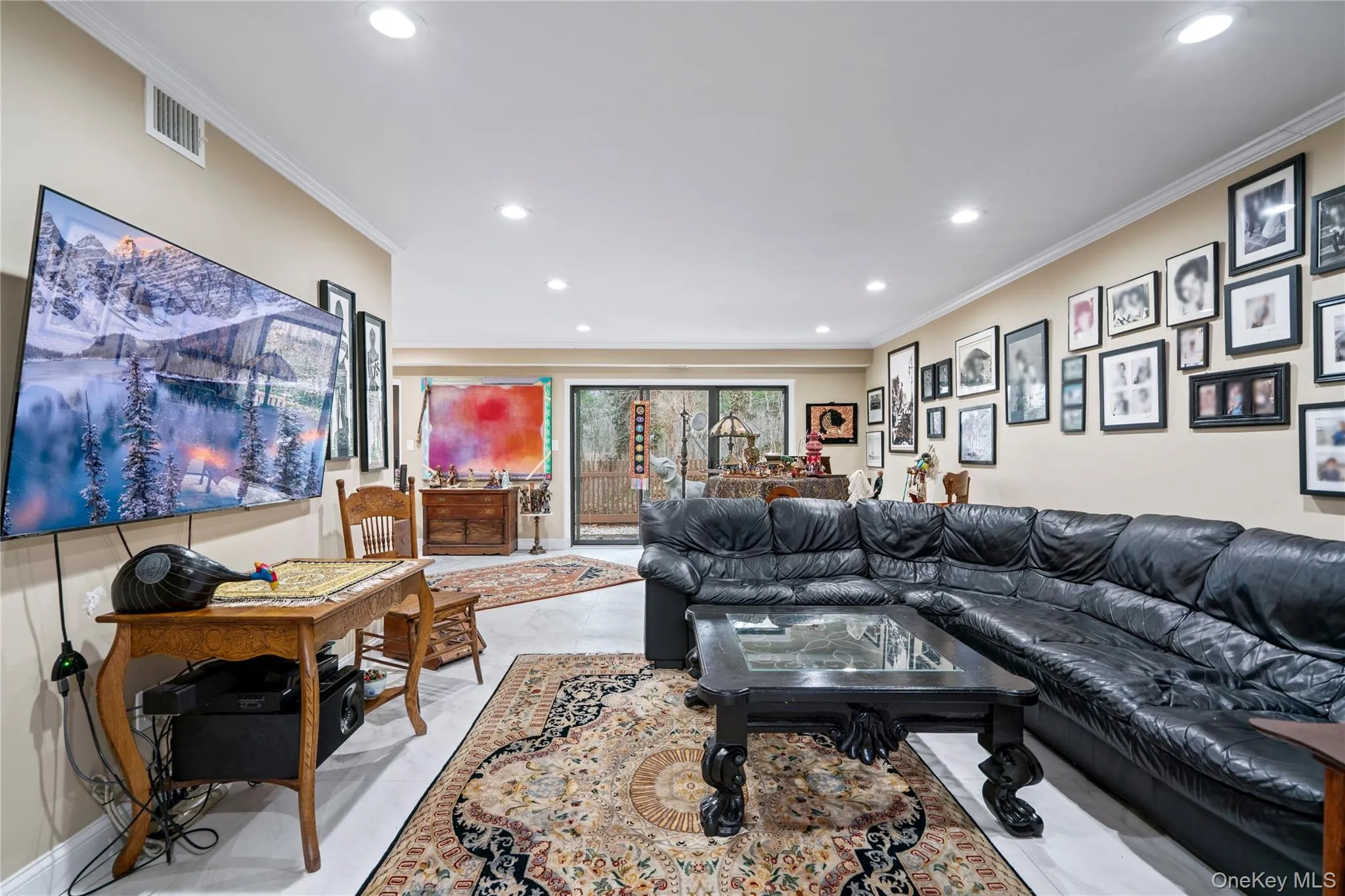 Living room featuring crown molding and recessed lighting Living room featuring crown molding and recessed lighting