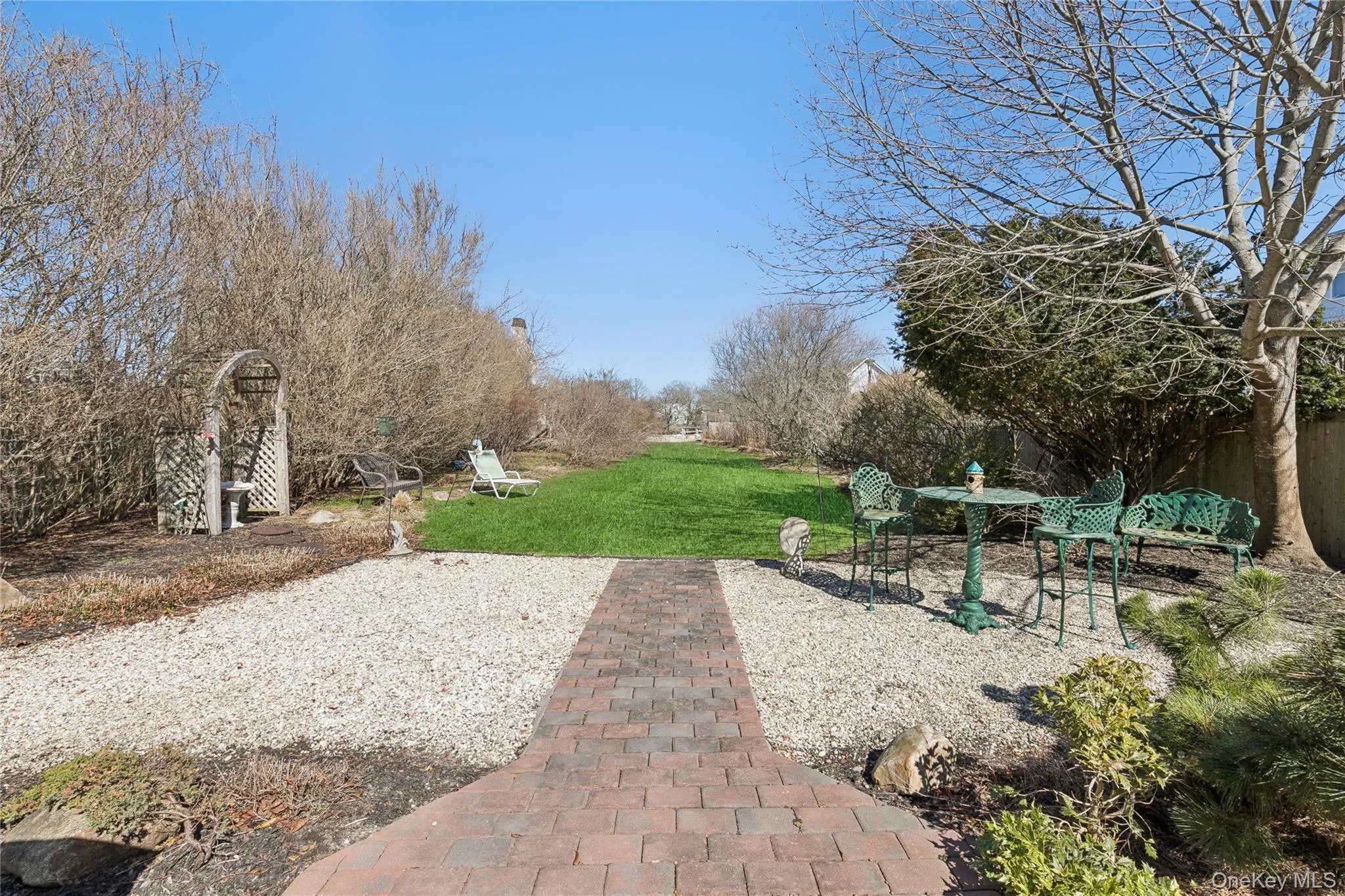 View Outside of Back of House. View of Pavers, Backyard, Beach and Canal