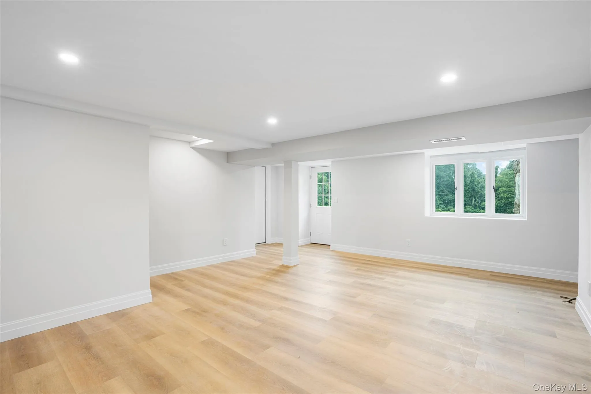 Basement featuring a full bathroom and access to backyard Basement featuring a full bathroom and access to backyard