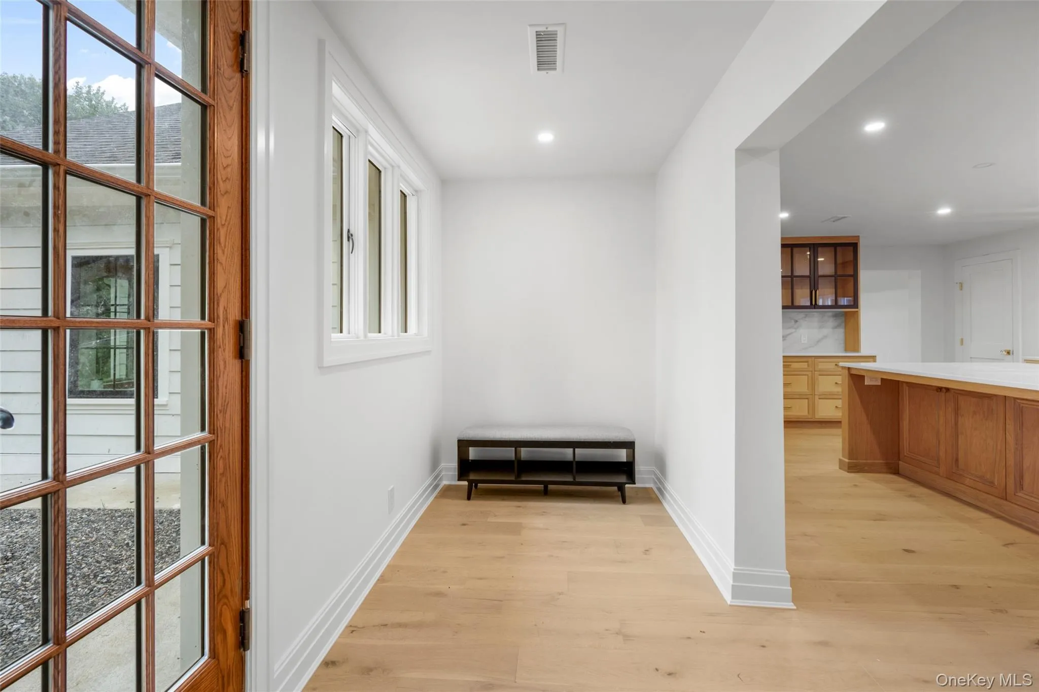 Mudroom entrance to kitchen with light wood-type flooring and recessed lighting Mudroom entrance to kitchen with light wood-type flooring and recessed lighting