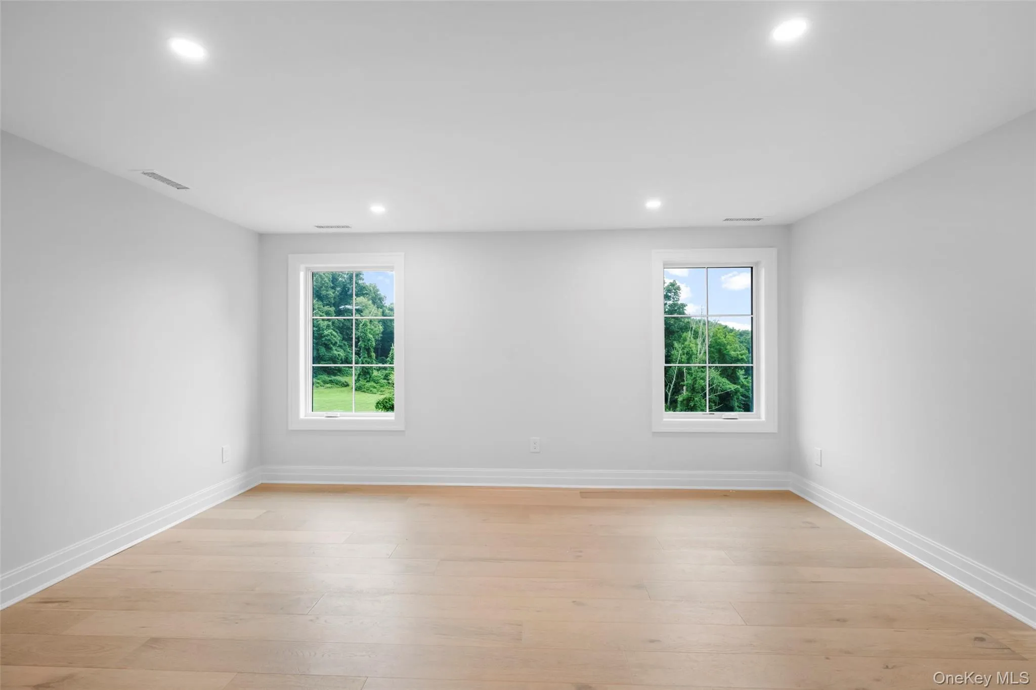 Unfurnished room featuring recessed lighting and light wood-style flooring Unfurnished room featuring recessed lighting and light wood-style flooring