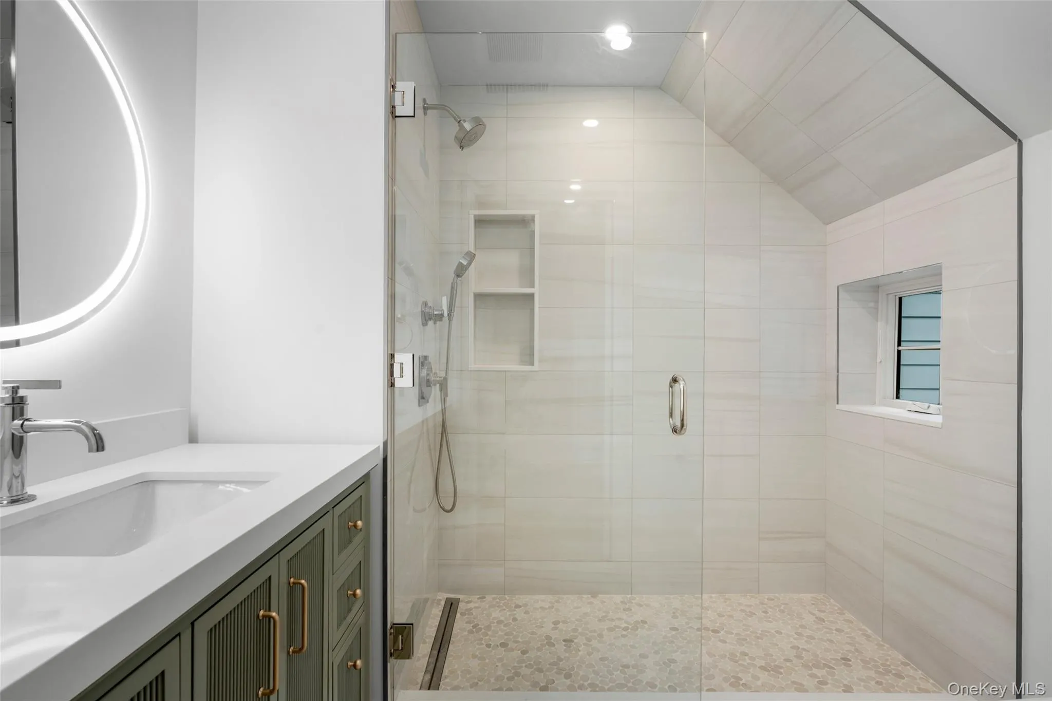 Bathroom with a shower stall, vanity, and vaulted ceiling Bathroom with a shower stall, vanity, and vaulted ceiling
