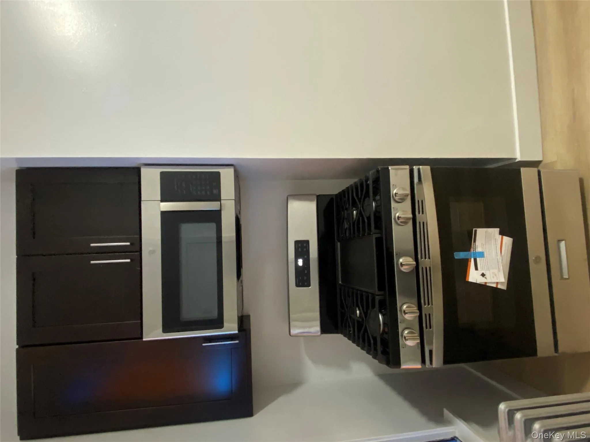 Kitchen featuring stainless steel appliances and light wood-style flooring Kitchen featuring stainless steel appliances and light wood-style flooring