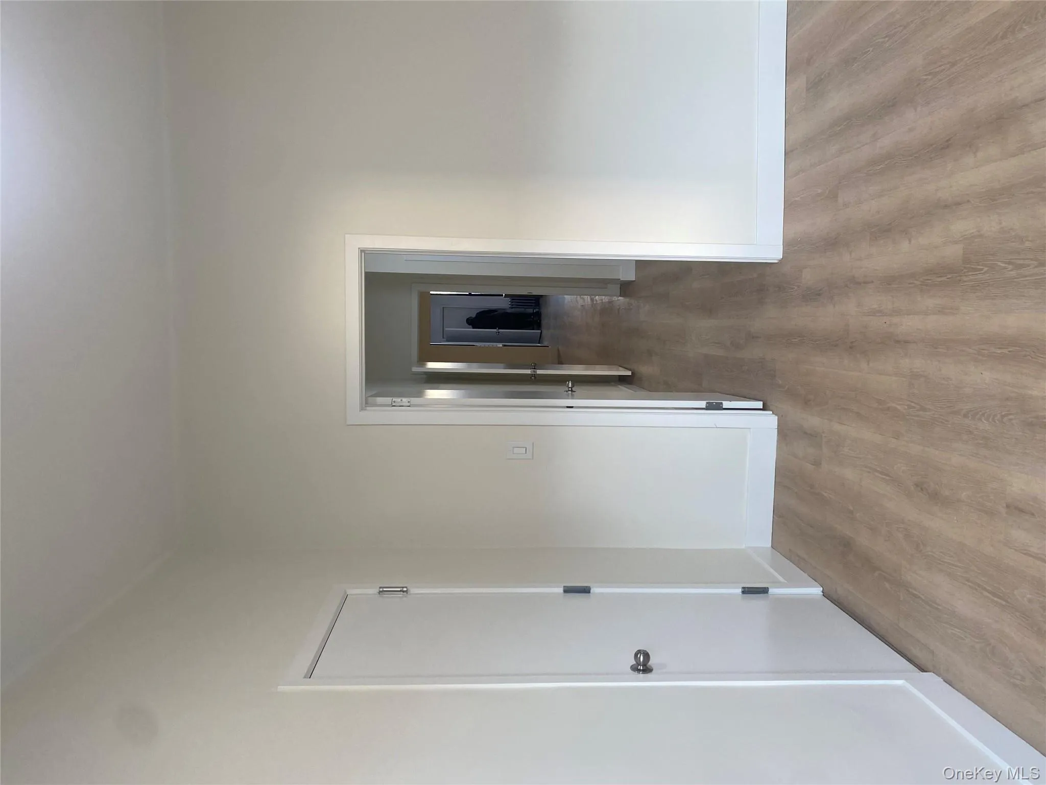 Corridor with light wood-style flooring and baseboards Corridor with light wood-style flooring and baseboards