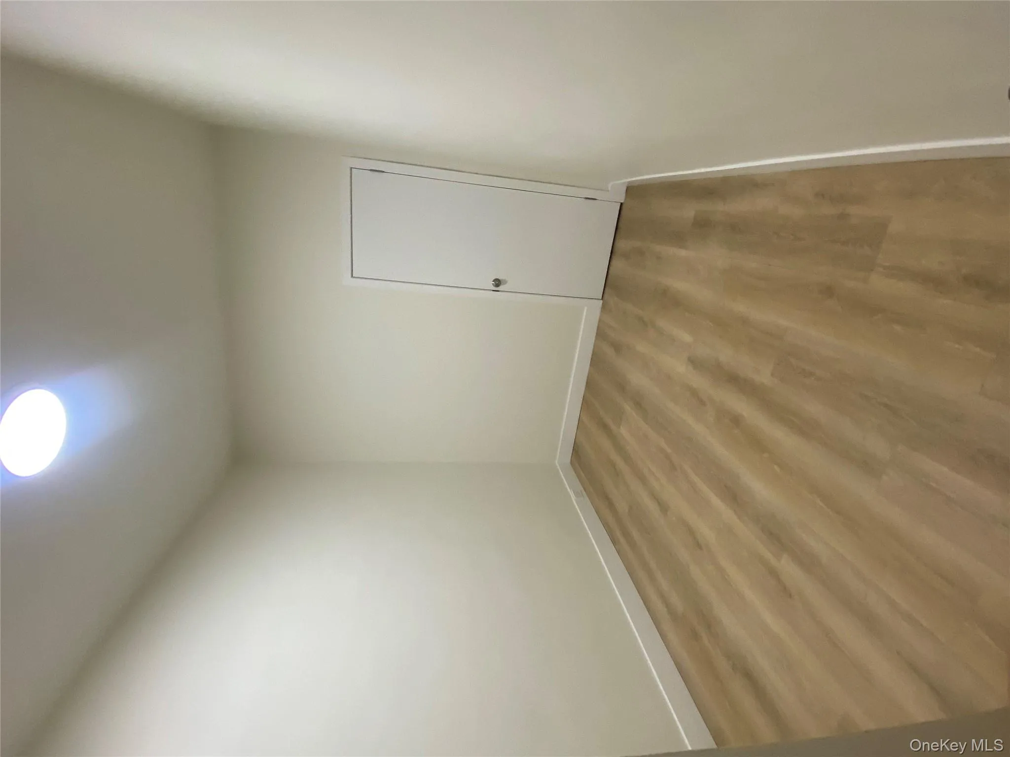 Empty room featuring wood finished floors and baseboards Empty room featuring wood finished floors and baseboards