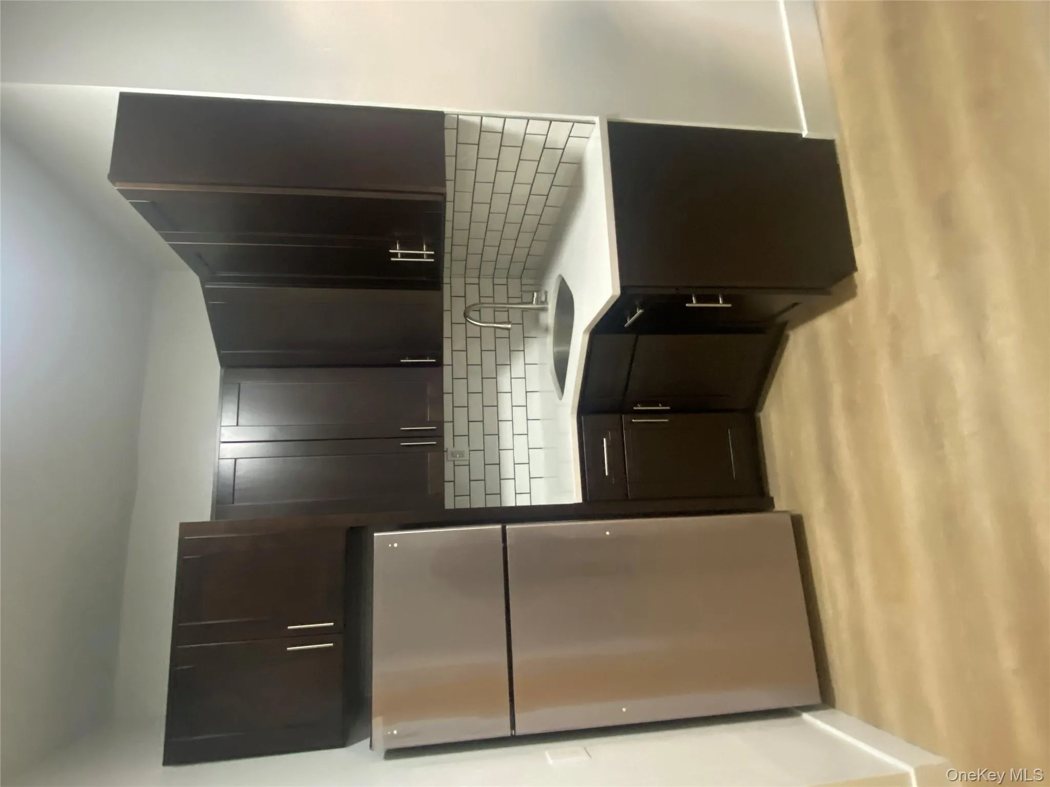 Kitchen featuring freestanding refrigerator, dark wood finish cabinetry, and light wood finished floors Kitchen featuring freestanding refrigerator, dark wood finish cabinetry, and light wood finished floors