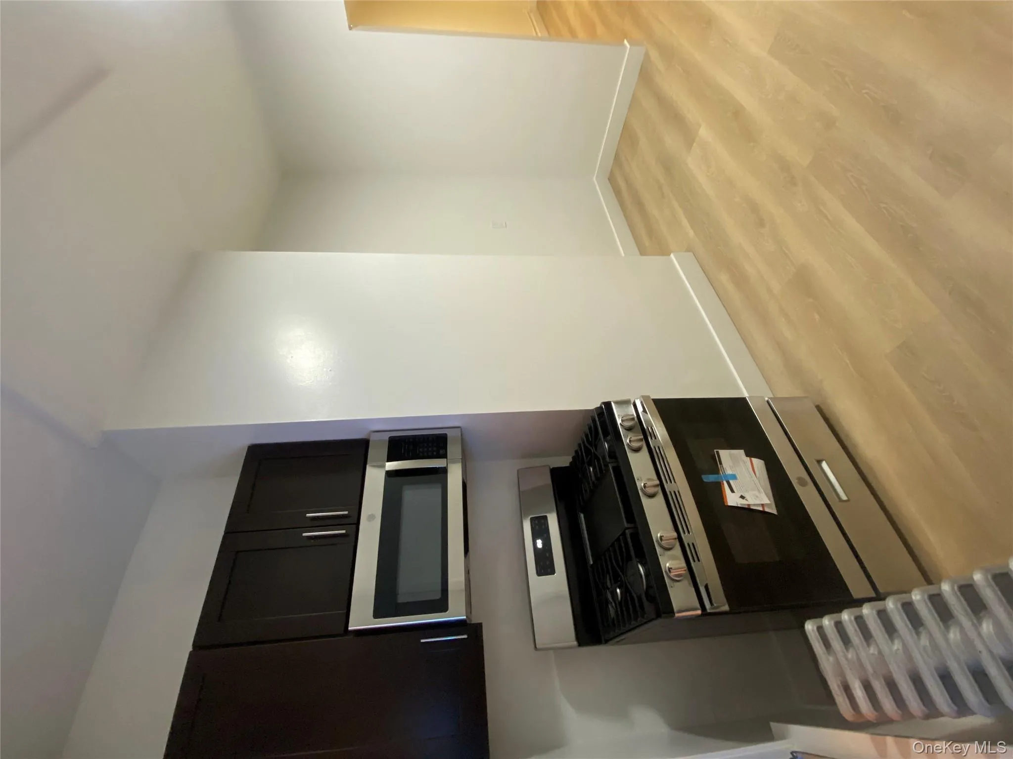Kitchen featuring stainless steel appliances and light wood-style floors Kitchen featuring stainless steel appliances and light wood-style floors