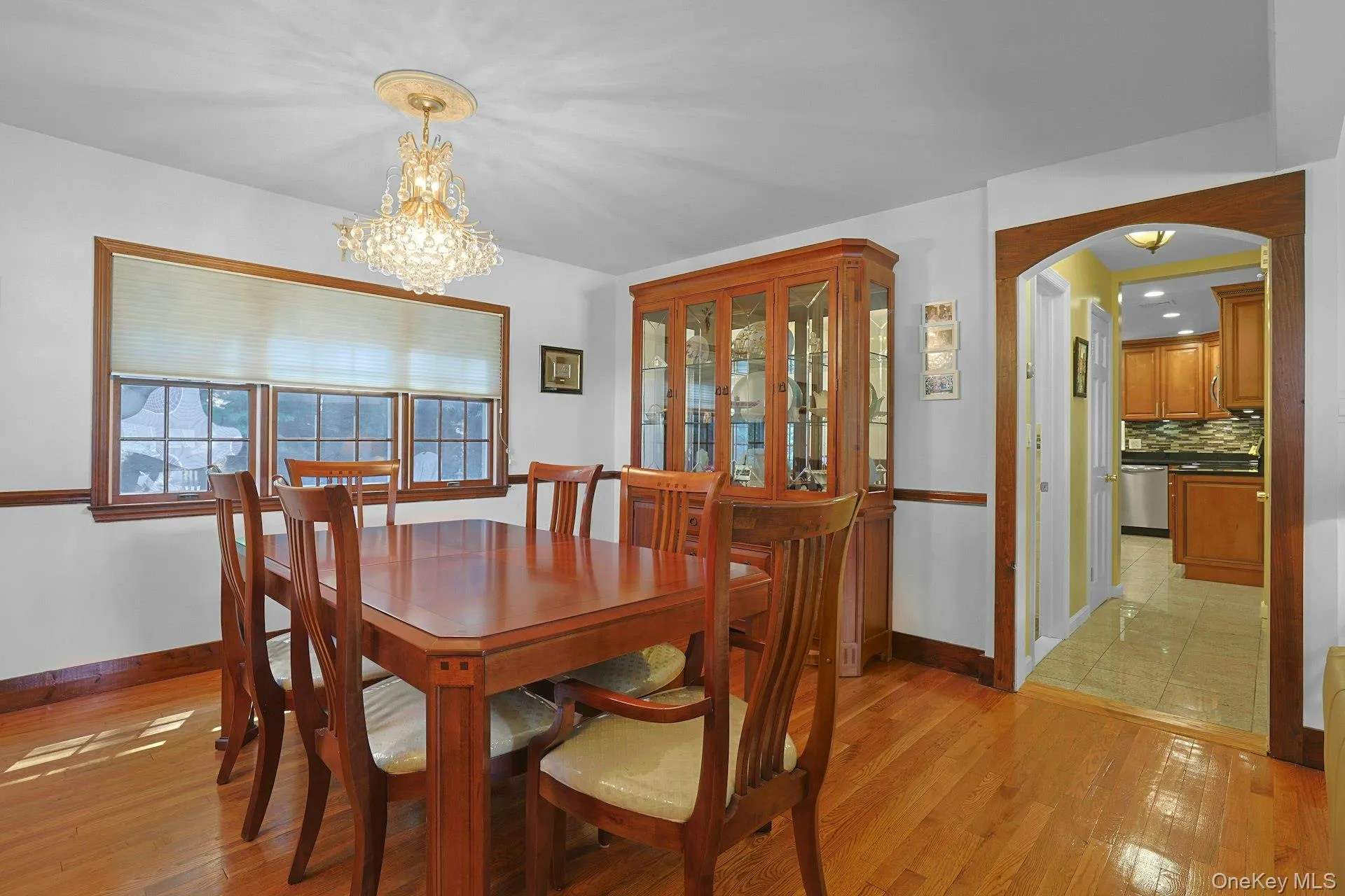 Dining Room featuring a chandelier, arched walkways, hardwood floors, plenty of natural light Dining Room featuring a chandelier, arched walkways, hardwood floors, plenty of natural light
