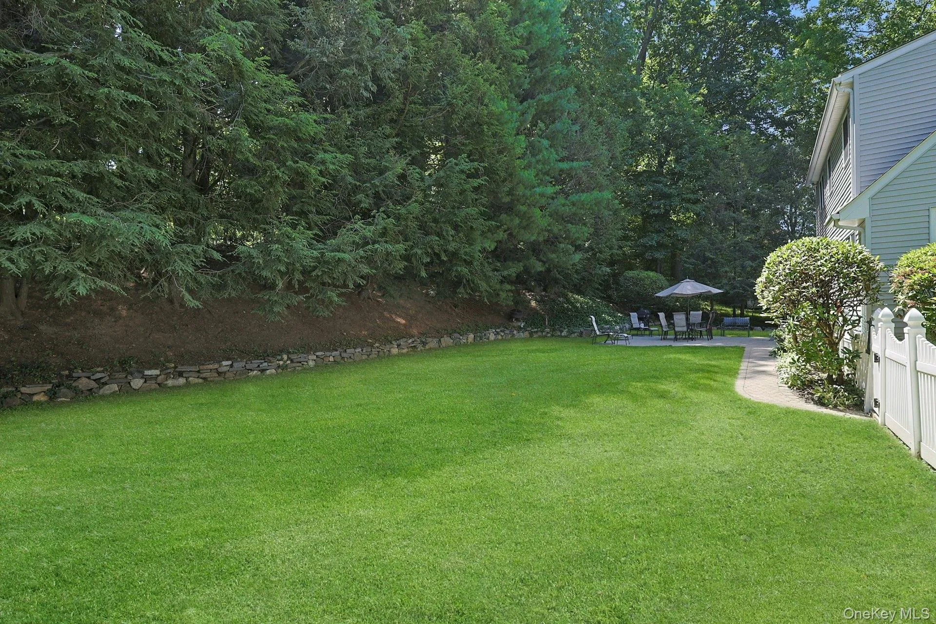 Another View of manicured yard featuring patio area Another View of manicured yard featuring patio area