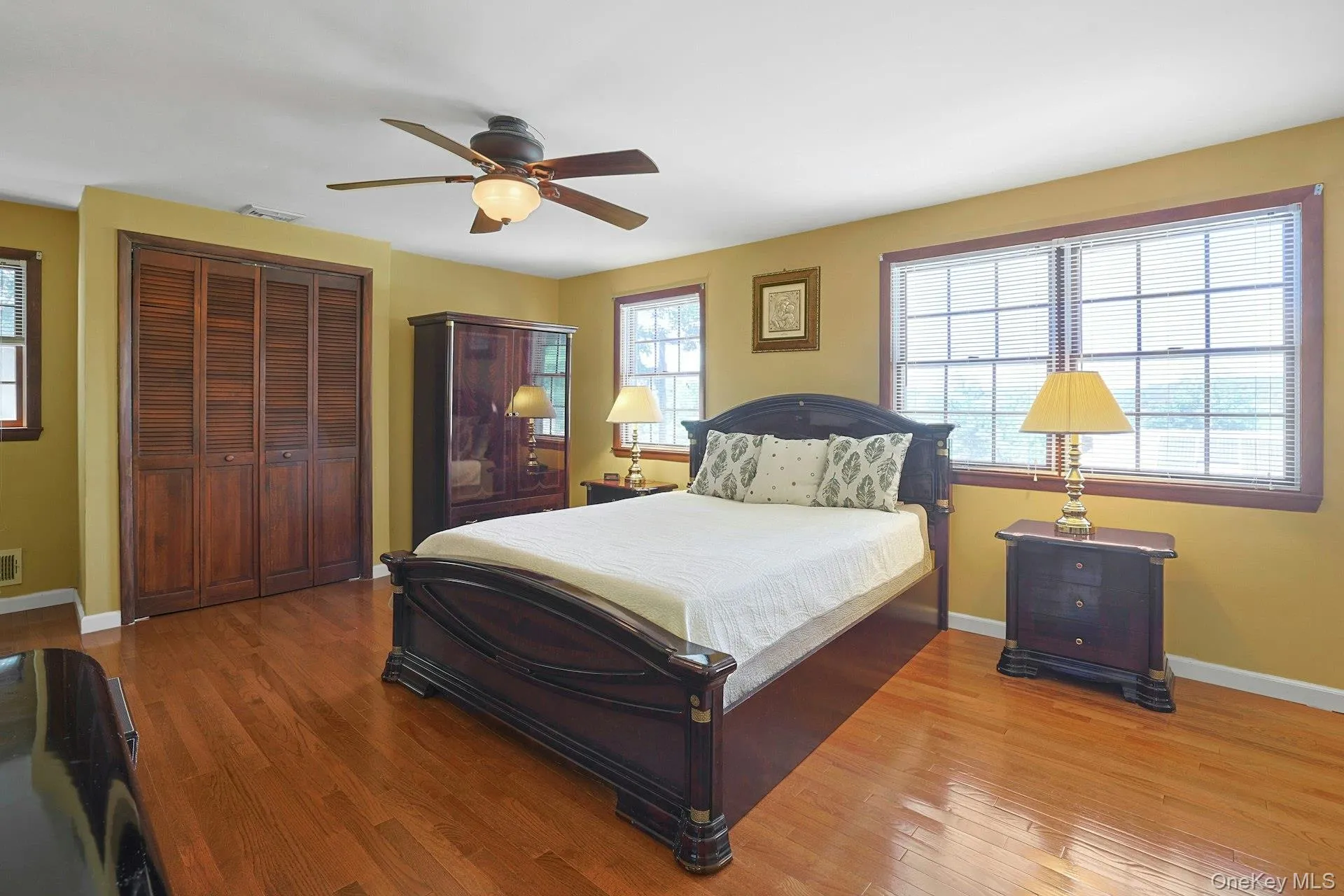 Primary bedroom features hardwood floors, three closets, ceiling fan Primary bedroom features hardwood floors, three closets, ceiling fan