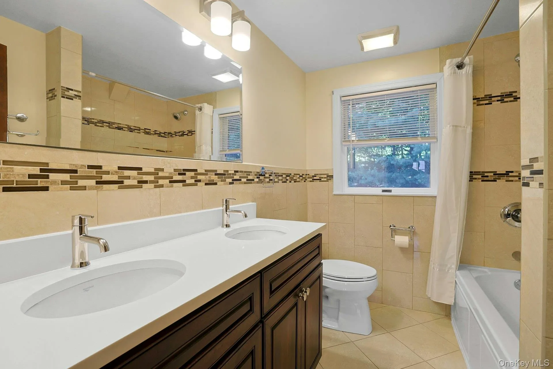 Second Floor Bathroom with tiled walls, tile patterned floors, shower / bathtub, double vanity, linen closet Second Floor Bathroom with tiled walls, tile patterned floors, shower / bathtub, double vanity, linen closet