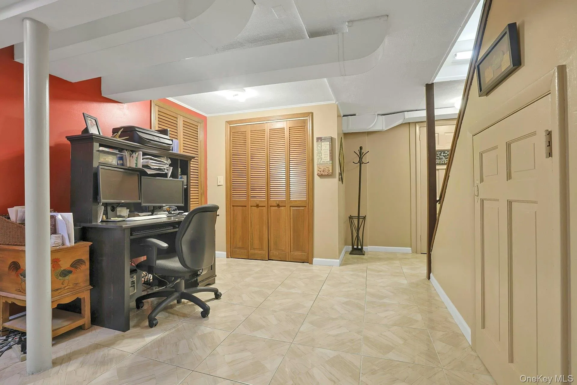Another view of basement showing office area, storage area under steps, and large closet Another view of basement showing office area, storage area under steps, and large closet