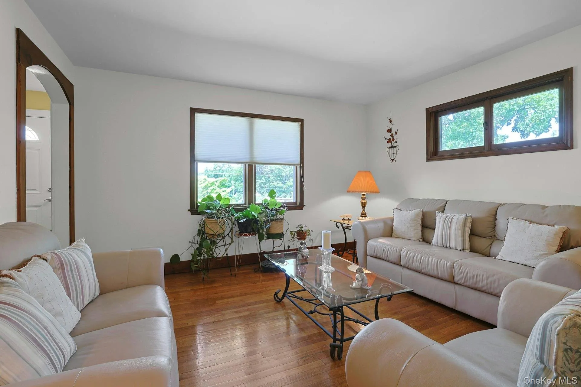 Living room featuring arched walkways, hardwood floors and plenty of natural light Living room featuring arched walkways, hardwood floors and plenty of natural light