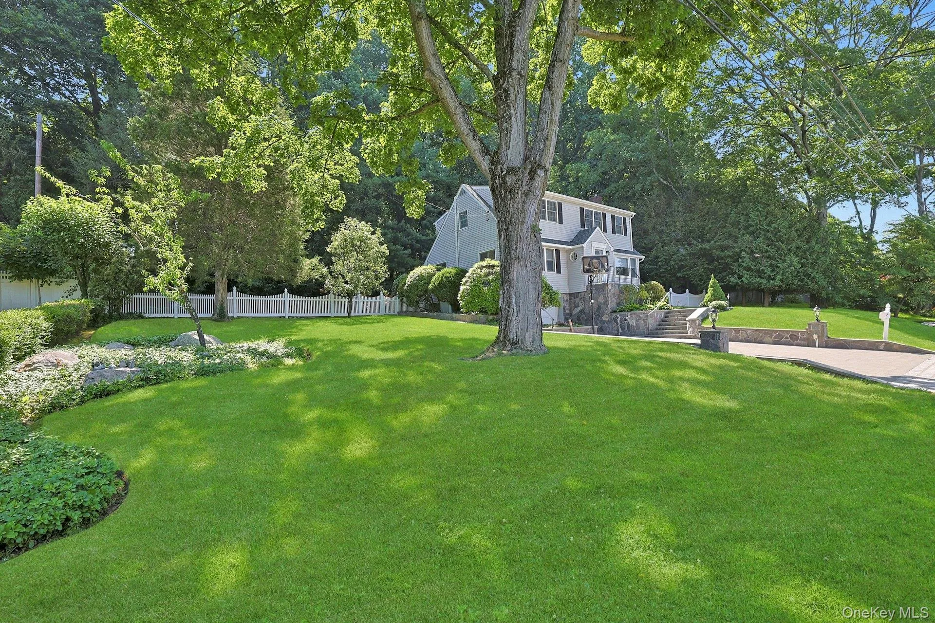 View of spacious and beautifully manicured side yard with stairway to driveway and back yard View of spacious and beautifully manicured side yard with stairway to driveway and back yard