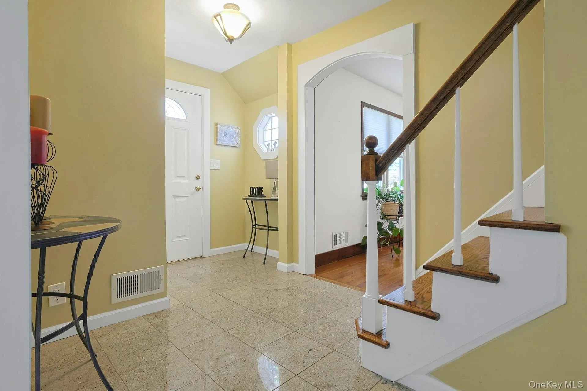 Inviting Entrance featuring stairway, arched walkways, and lofted ceiling Inviting Entrance featuring stairway, arched walkways, and lofted ceiling