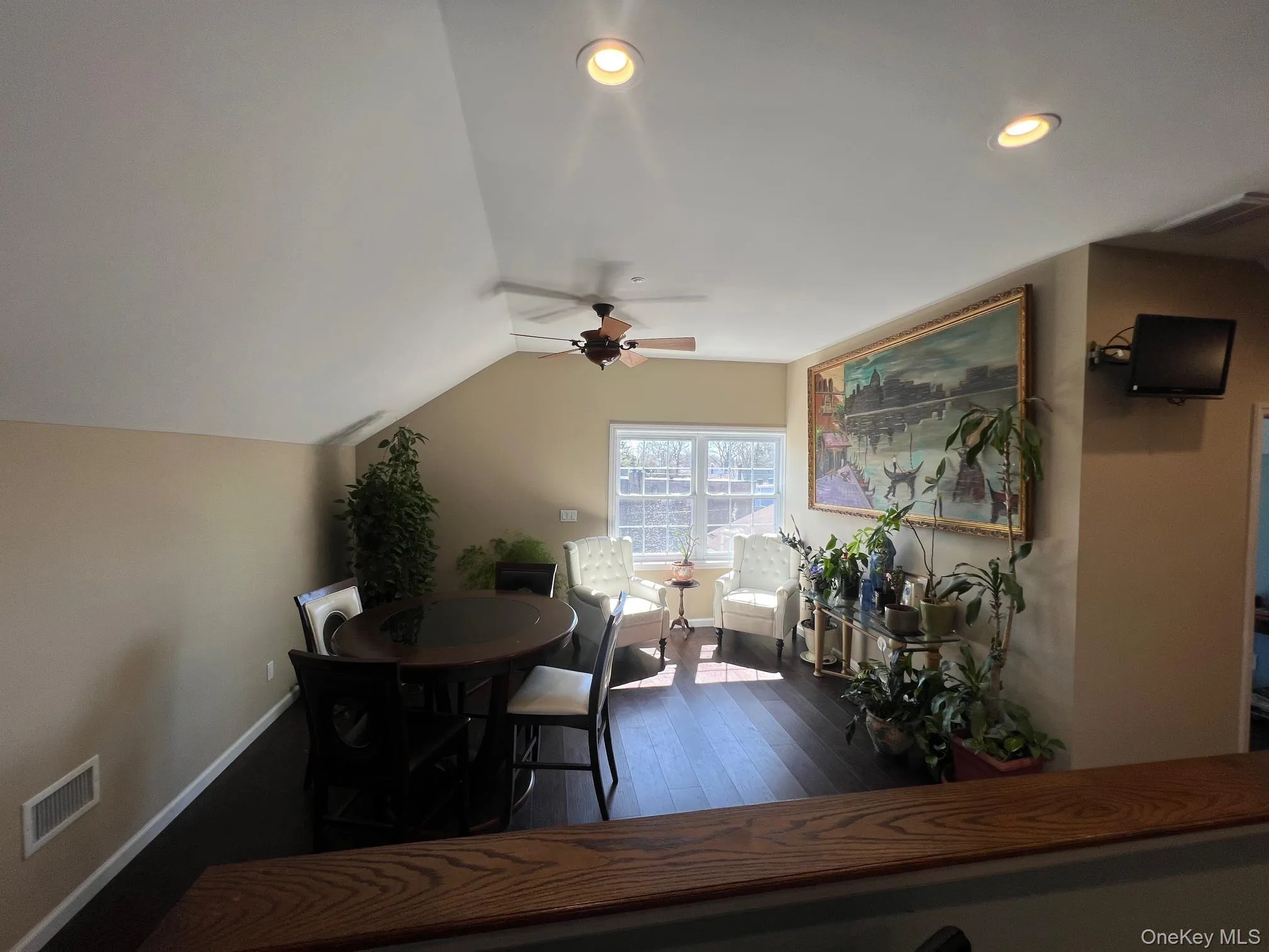 Dining space featuring lofted ceiling, a ceiling fan, dark wood finished floors, and recessed lighting Dining space featuring lofted ceiling, a ceiling fan, dark wood finished floors, and recessed lighting