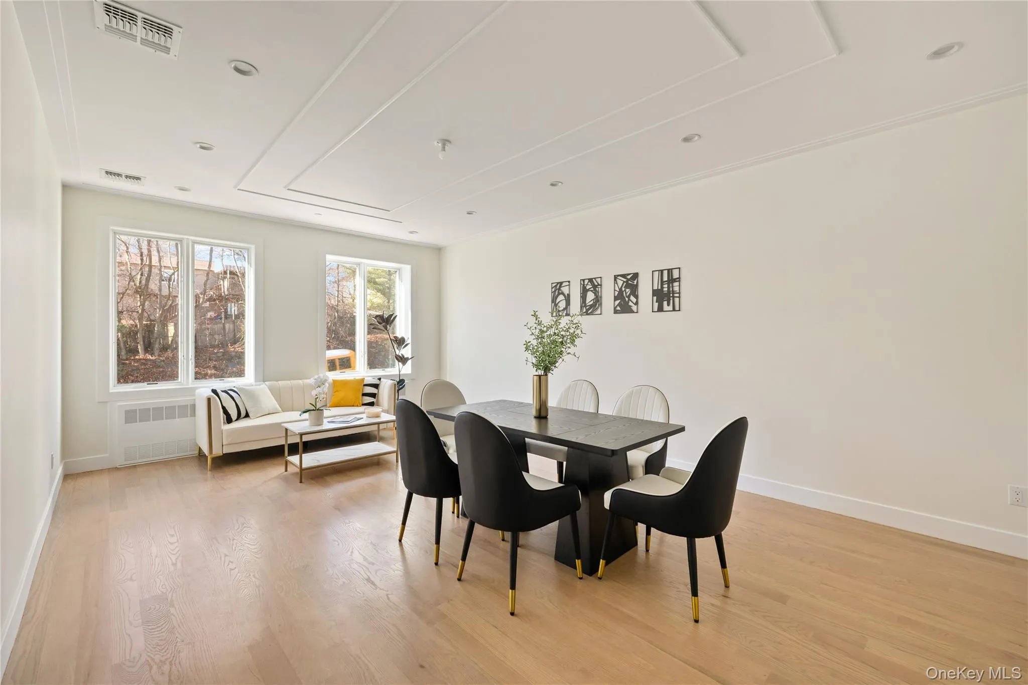 Dining space featuring light wood finished floors, radiator heating unit, and recessed lighting Dining space featuring light wood finished floors, radiator heating unit, and recessed lighting