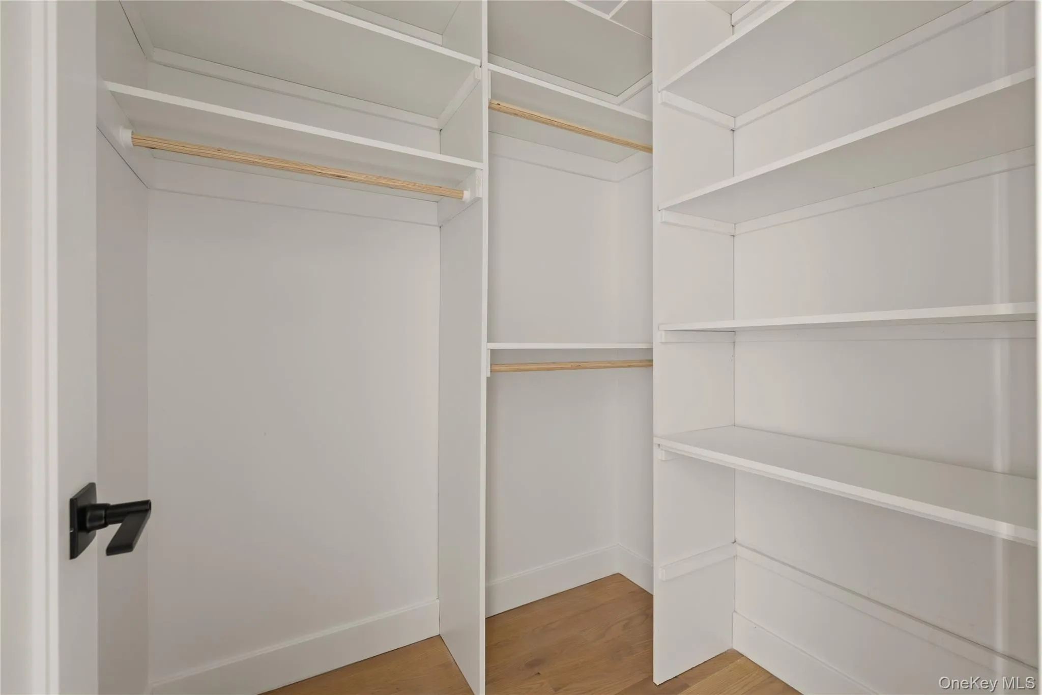 Spacious closet featuring light wood-type flooring Spacious closet featuring light wood-type flooring