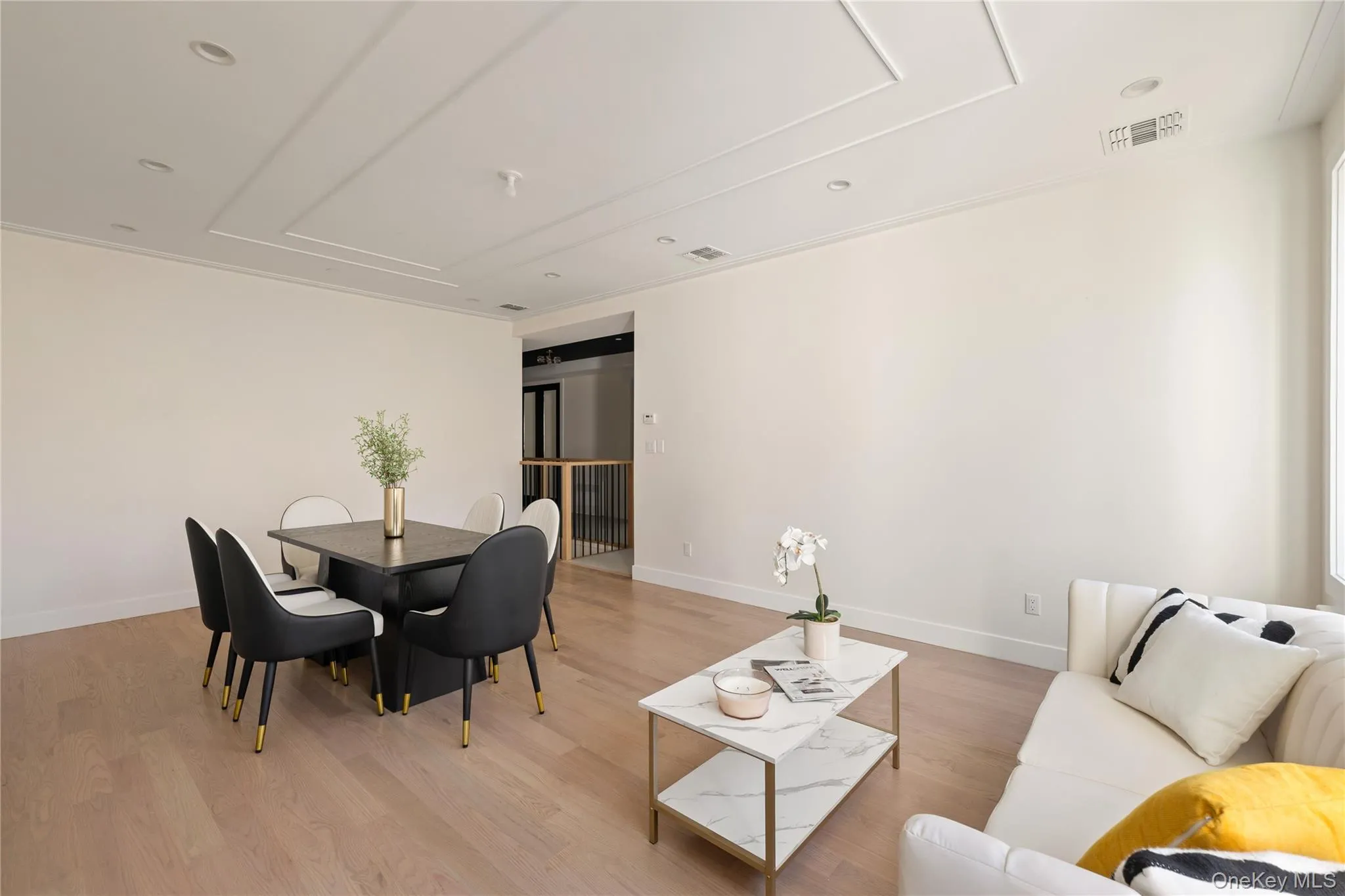 Living room with light wood finished floors and recessed lighting Living room with light wood finished floors and recessed lighting