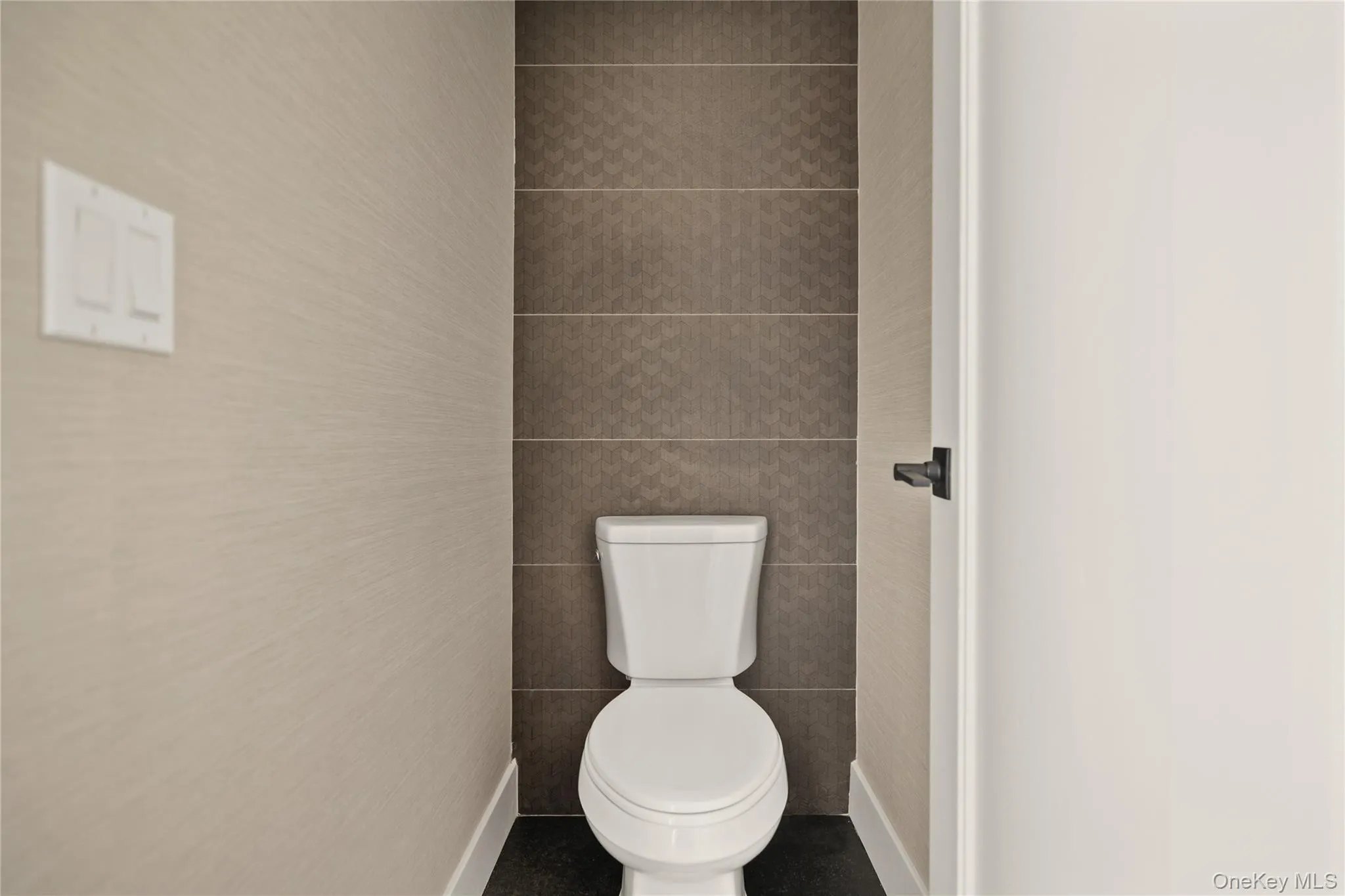 Bathroom with toilet and tile walls Bathroom with toilet and tile walls