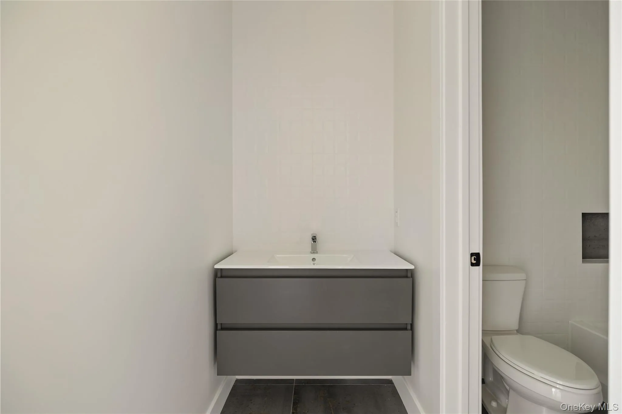 Bathroom featuring vanity and toilet Bathroom featuring vanity and toilet