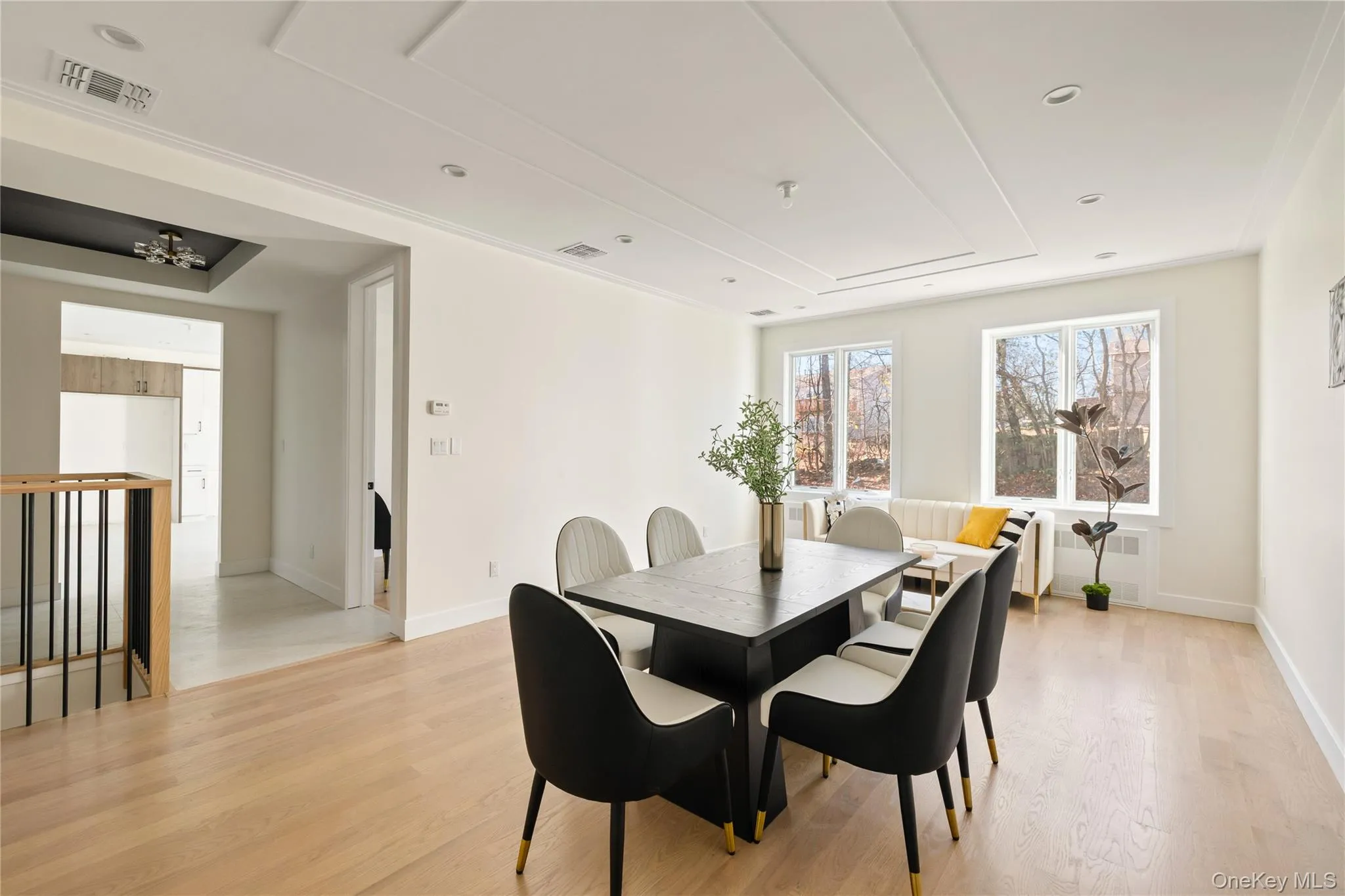 Dining area with light wood-style flooring, radiator heating unit, and recessed lighting Dining area with light wood-style flooring, radiator heating unit, and recessed lighting