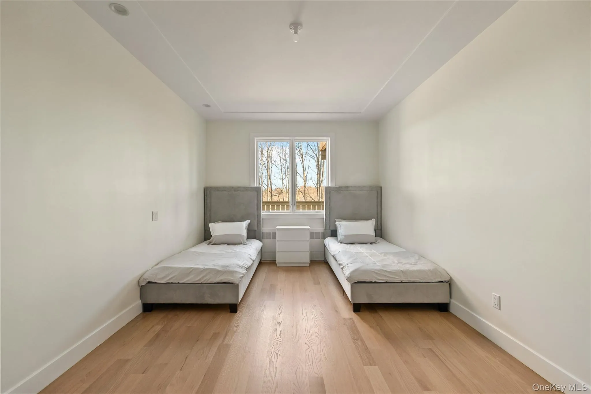 Bedroom with light wood-style floors and baseboards Bedroom with light wood-style floors and baseboards