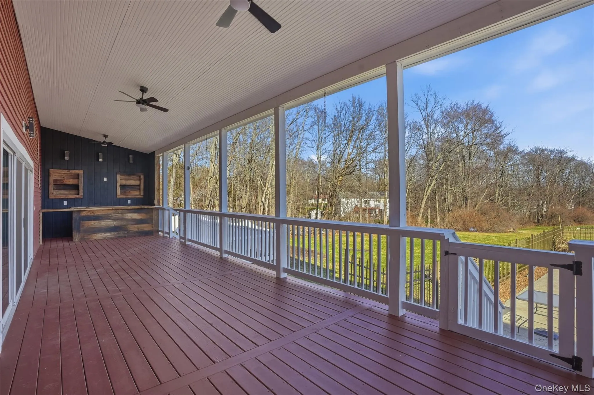 Expansive covered back deck with custom built entertainment bar with 100-year-old reclaimed wood from the property. Expansive covered back deck with custom built entertainment bar with 100-year-old reclaimed wood from the property.