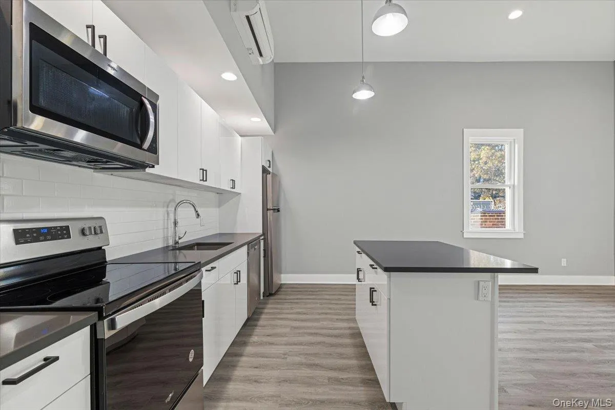 Modern kitchen with quartz countertops and stainless steel appliances. Modern kitchen with quartz countertops and stainless steel appliances.