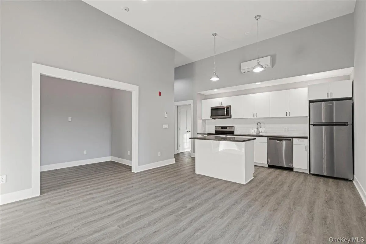 Bright, open-concept living space with high ceilings and a loft-like feel. Bright, open-concept living space with high ceilings and a loft-like feel.